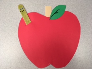 red apple with smiling "worm"