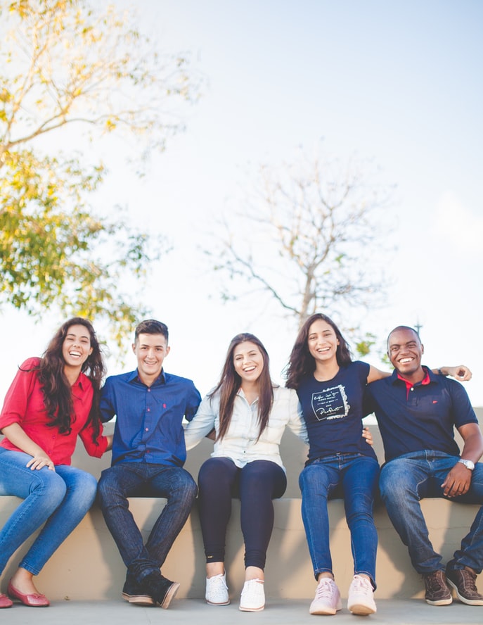 young adults on a bench laughing