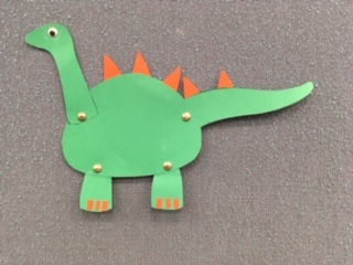 green dinosaur with orange spikes and movable neck, tail and legs