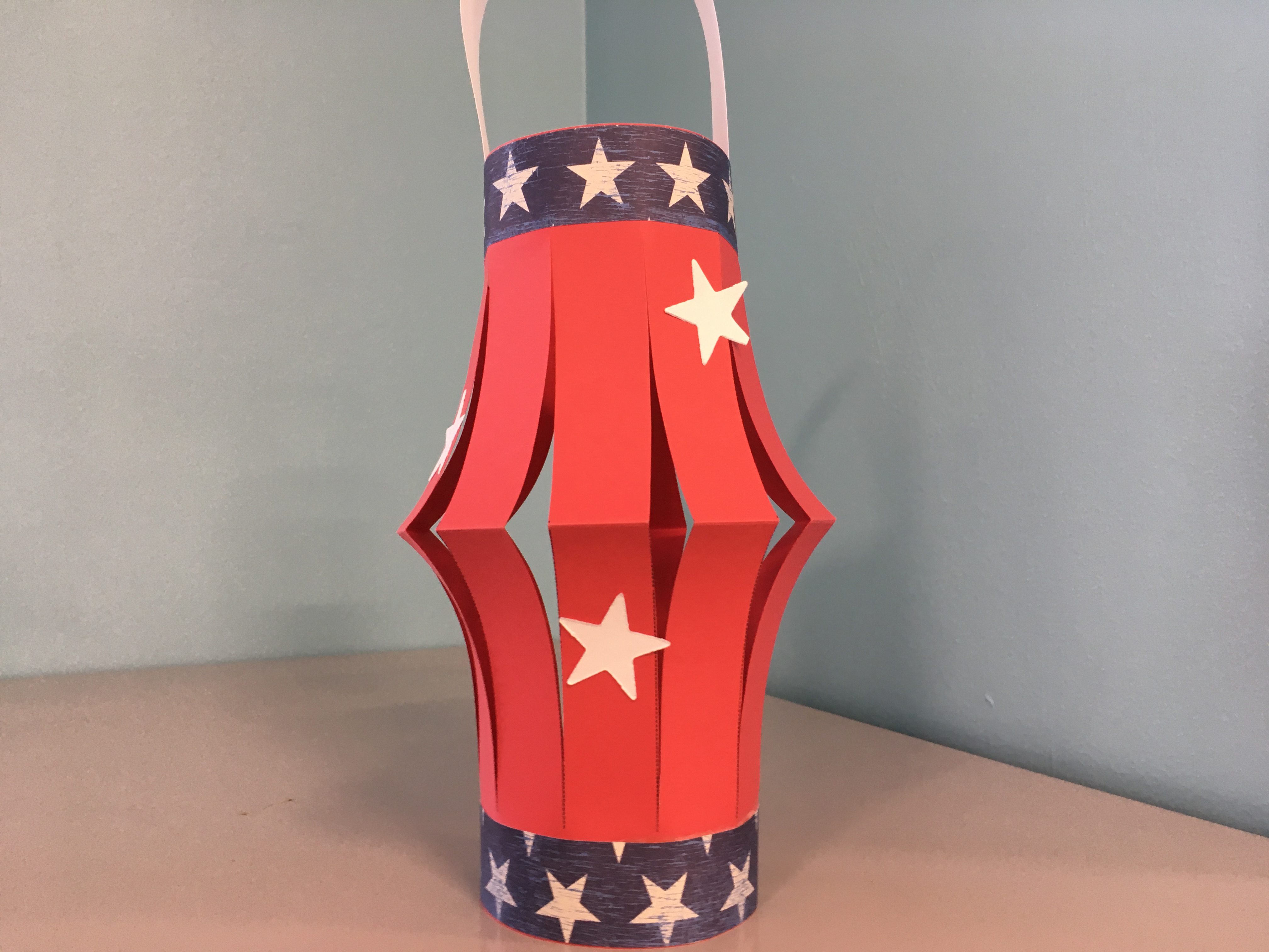 red paper lantern with white stars and blue border