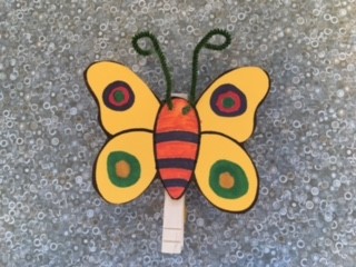 gold butterfly with chenille stem antenna and clothespin clip