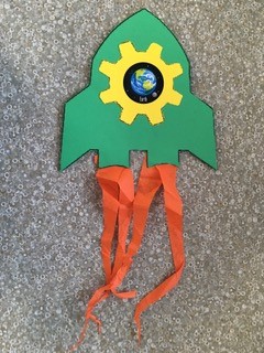 green paper rocket with orange streamers