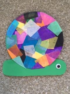 green snail with multi-color paper square shell