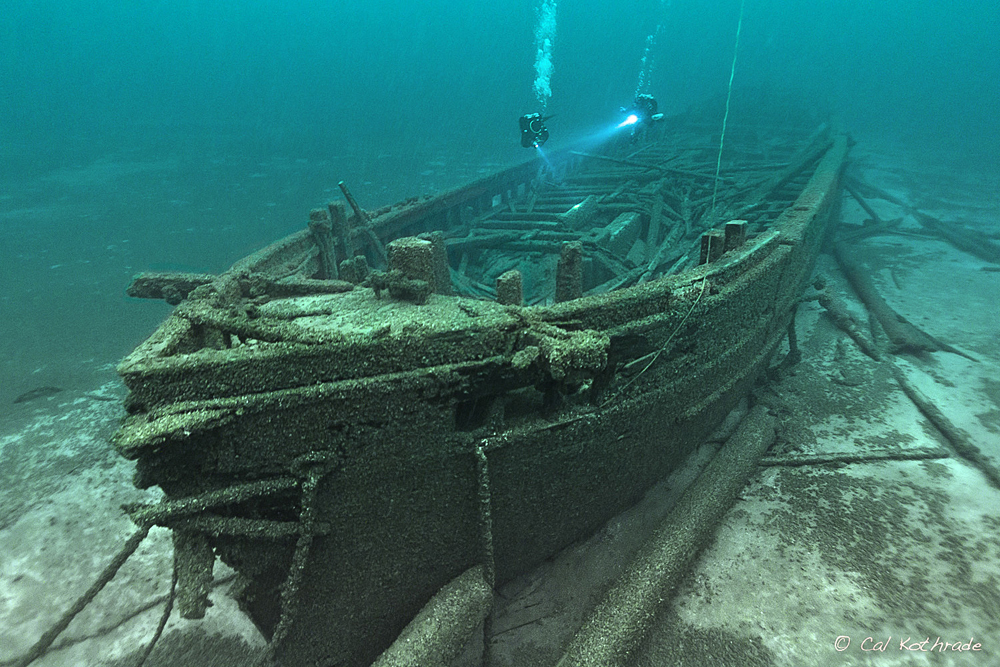 divers investigating underwater shipwreck