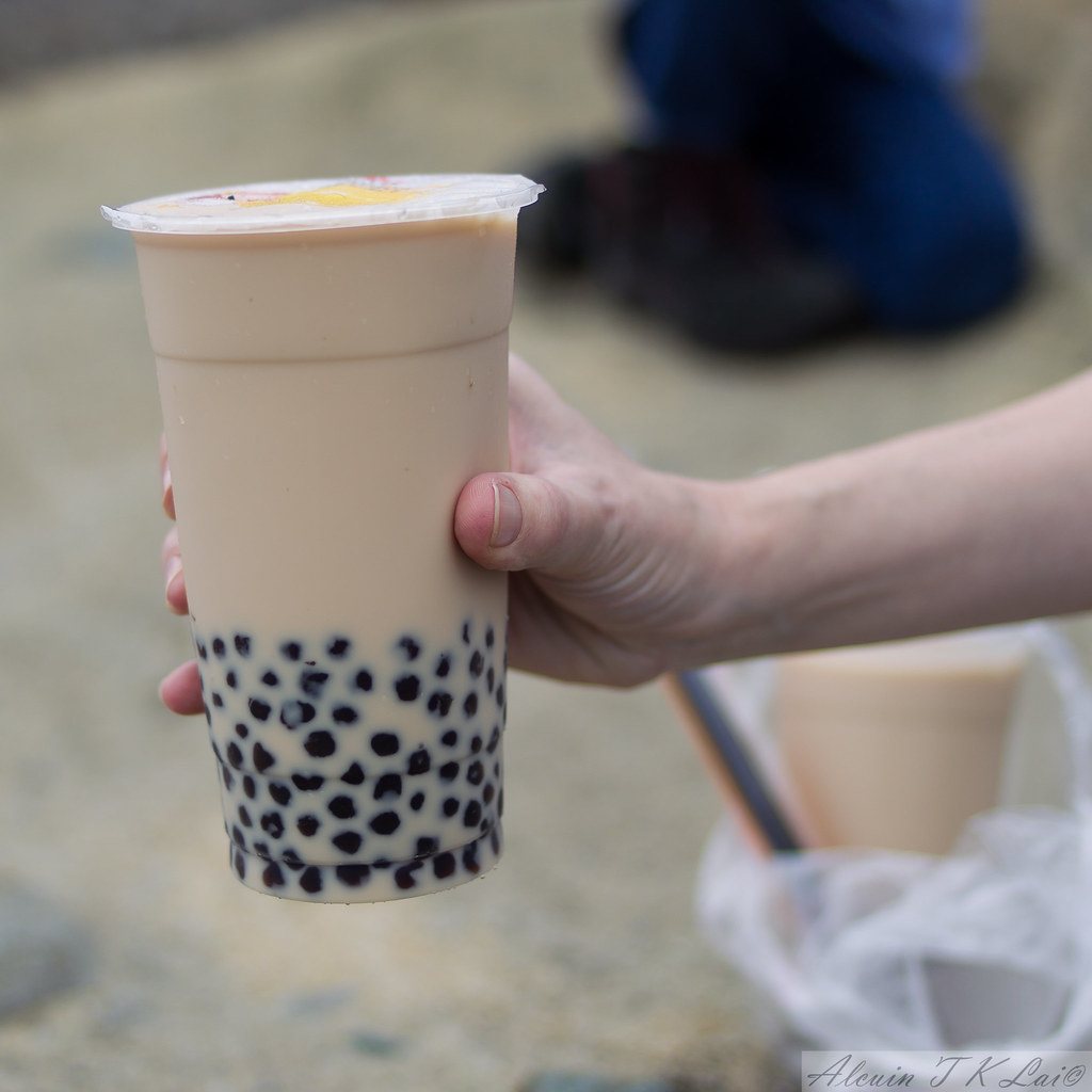 Person holding a cup of bubble tea.