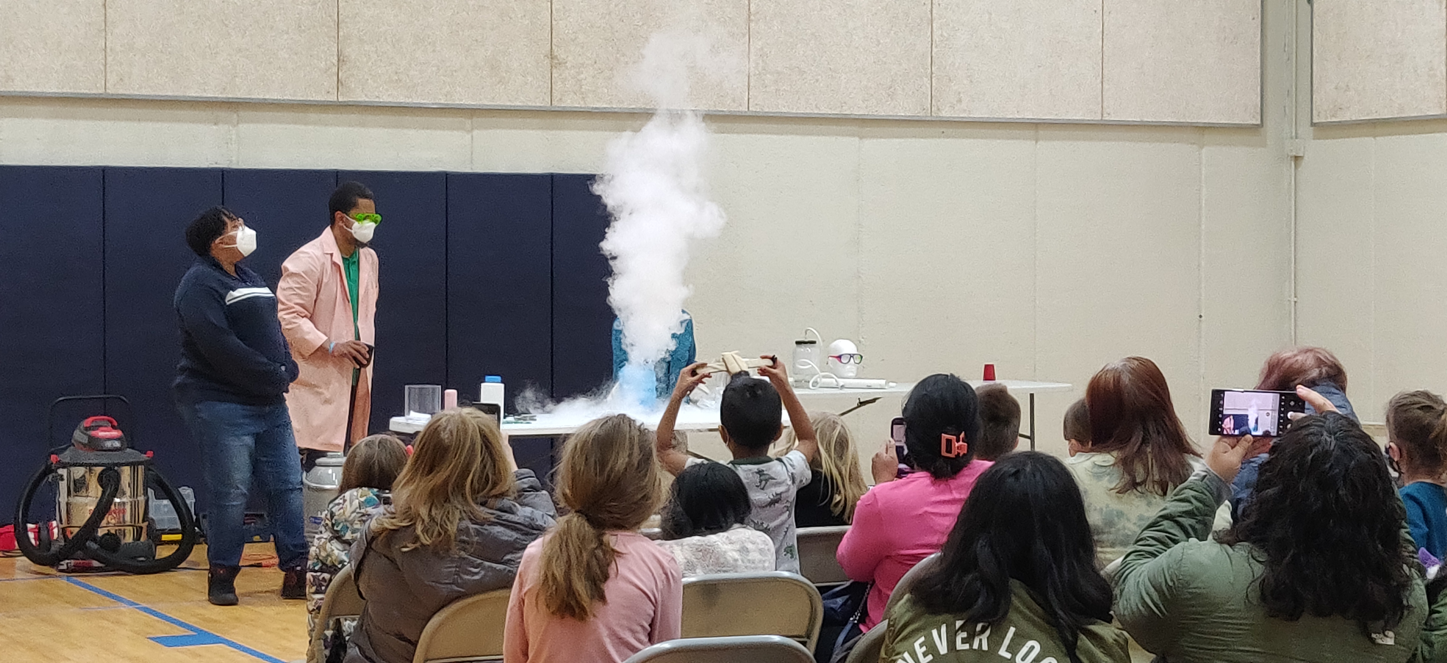 Patrick Cobb setting off an experiment causing smoke in a bottle.