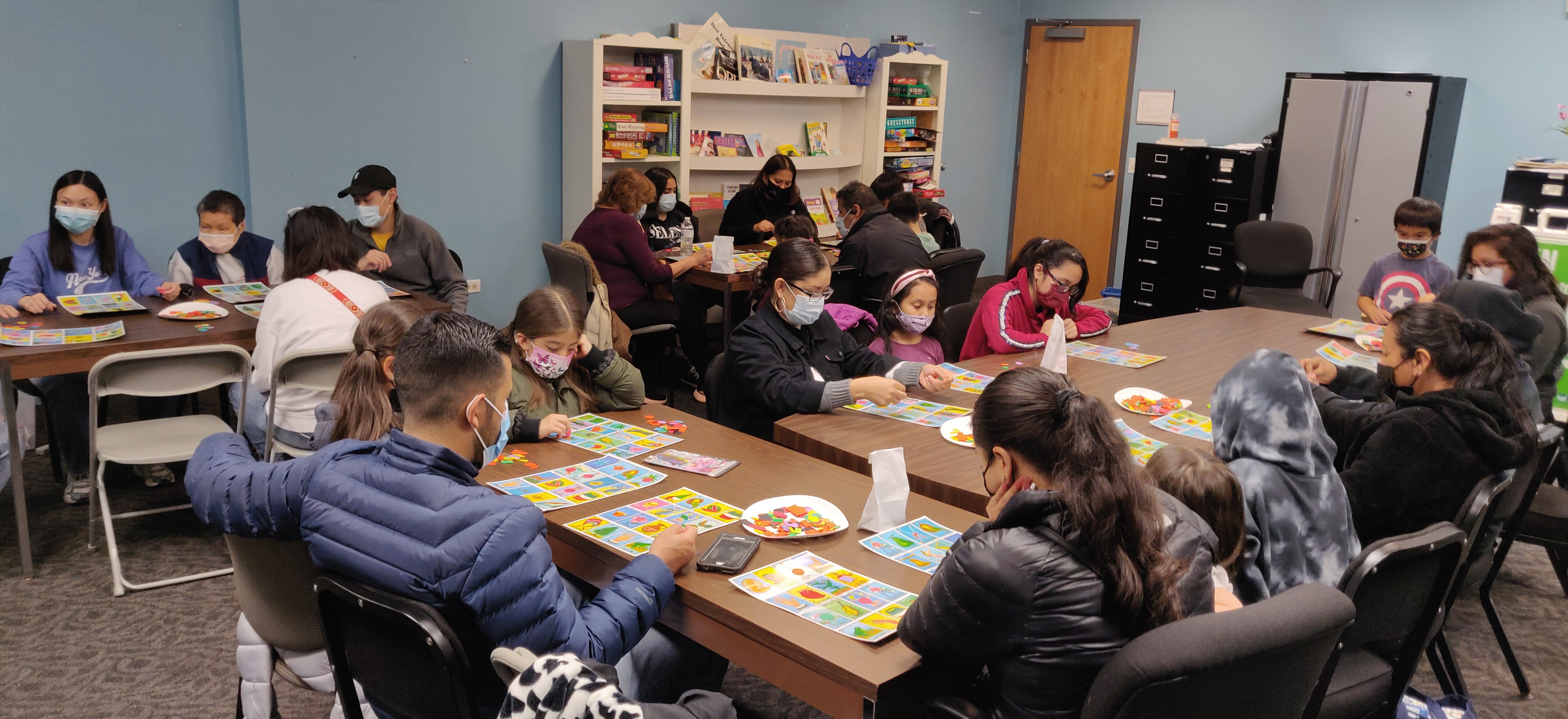 Families from Rand Road concentrating on their Loteria cards.