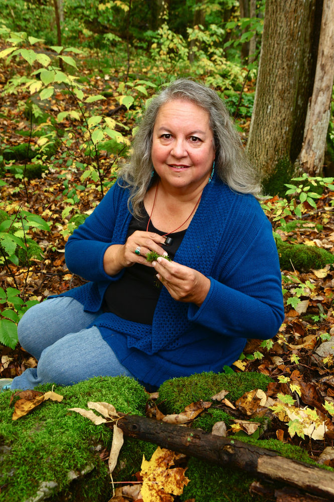 Robin Wall Kimmerer in a forest