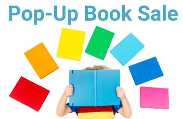 Rainbow of books with child holding a book