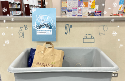 Winter Reading Challenge logo and donation bin