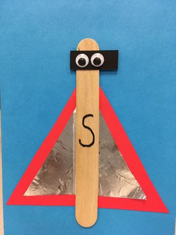 superhero stick puppet with red cape, black mask and wiggle eyes