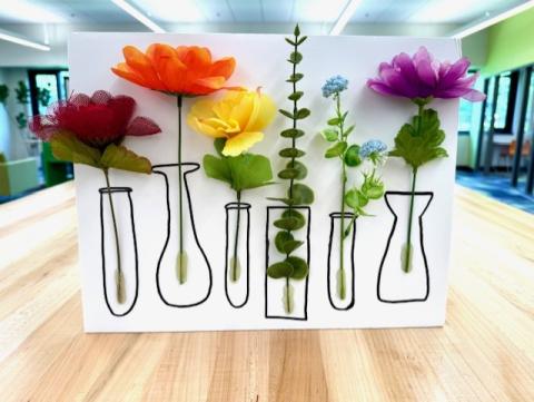 Photo of art with hand drawn flower vases each with a different colored flower inside. 