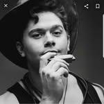 musician holding harmonica up to face